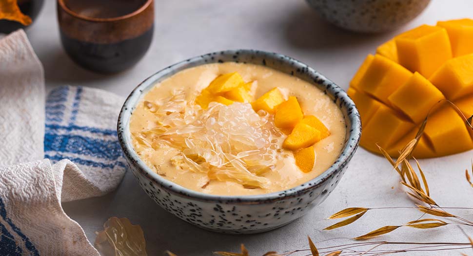 chilled mango pomelo sago in a bowl with mango cubes and fresh pomelo