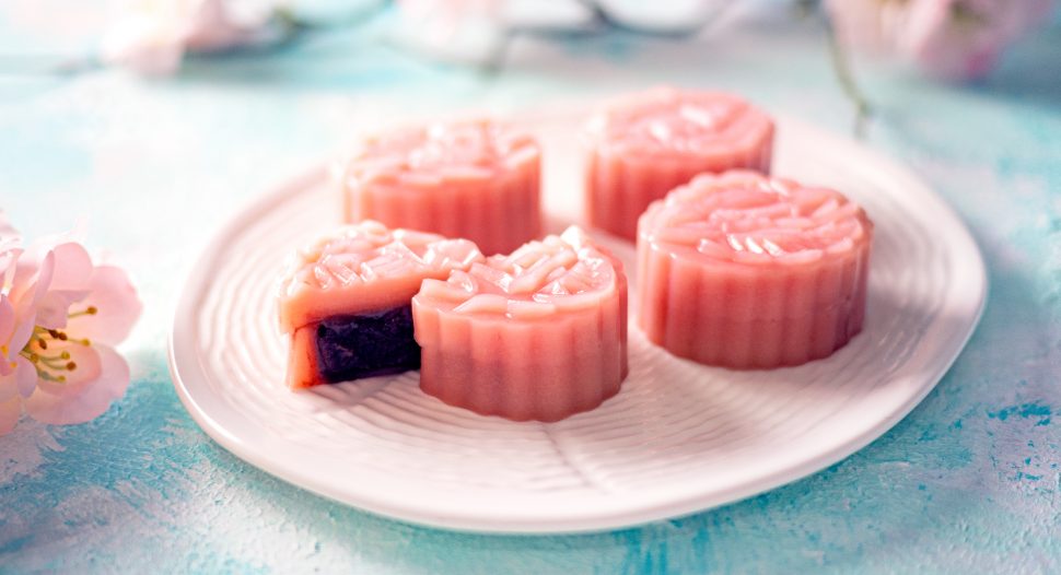 pink jelly mooncake with red bean paste filling on a white plate for mid autumn festival