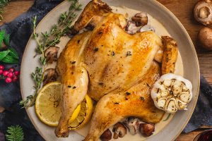 traditional roast chicken served with white wine mushroom cream sauce and herbs